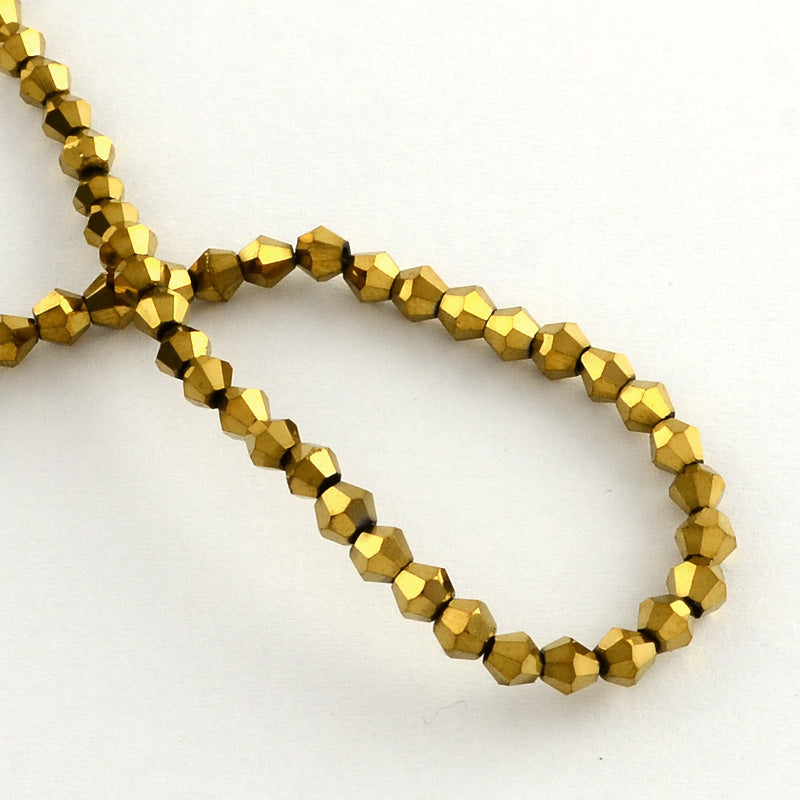 Små Fasetterade Biconformade Glaspärlor 3x3,5mm Guldpläterade, 1 sträng (ca 105st)