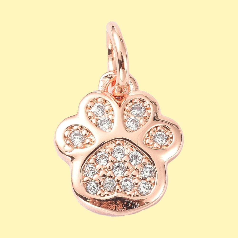 Tassavtrycksformad berlock med mikroinfattade cubic zirconia i roséguldfärg.