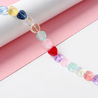 Glaspärlor hjärtformade ca 10mm transparent färgmix, 1 sträng (33cm)