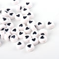 Akrylpärlor 7x4mm Vita med Svarta hjärtan, 50-pack